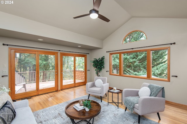 living area featuring french doors, ceiling fan, high vaulted ceiling, and light hardwood / wood-style flooring