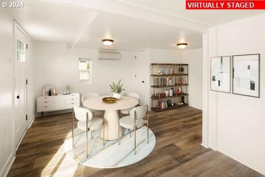 dining room with dark wood-style flooring and a wall unit AC