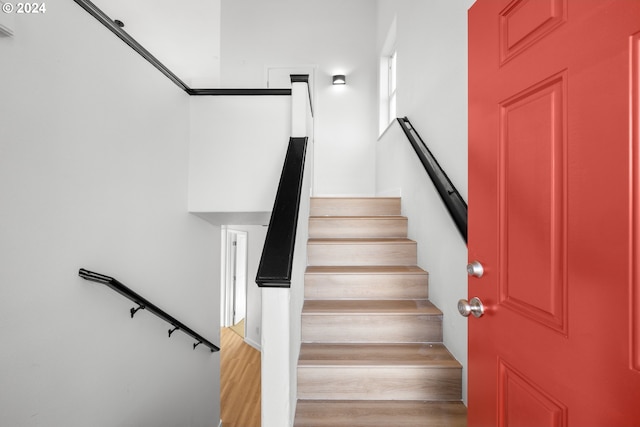 stairs featuring hardwood / wood-style flooring