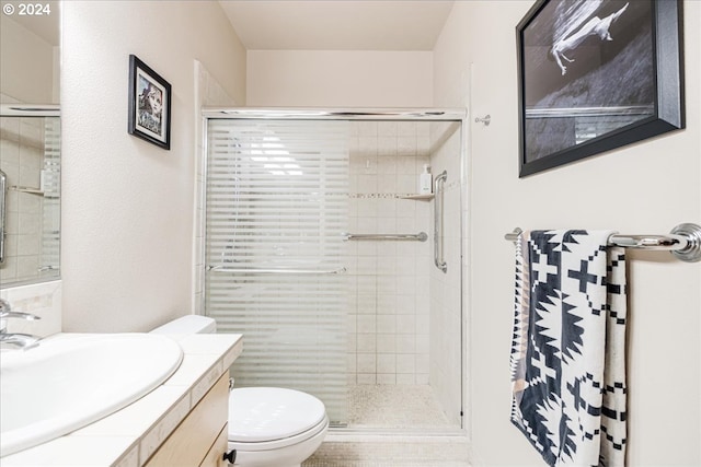 bathroom featuring walk in shower, vanity, and toilet