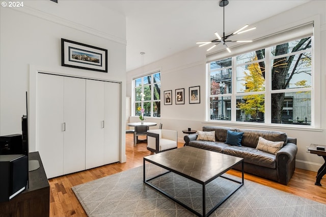 living room featuring an inviting chandelier and light hardwood / wood-style flooring