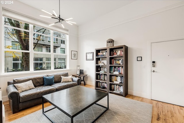 living room with a notable chandelier and light wood-type flooring