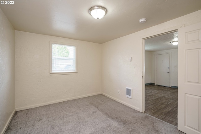 spare room featuring dark hardwood / wood-style floors