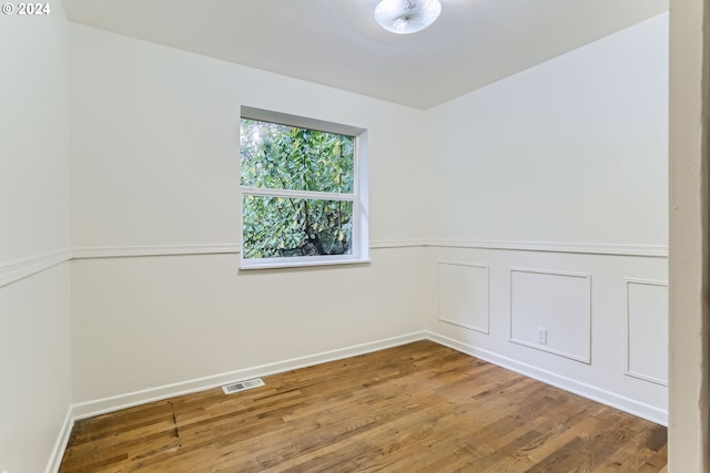 empty room with hardwood / wood-style floors