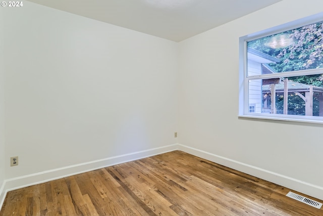 unfurnished room with wood-type flooring