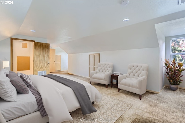 bedroom featuring vaulted ceiling and light carpet