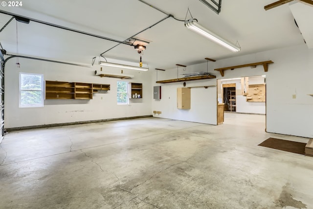 garage featuring electric panel and a garage door opener