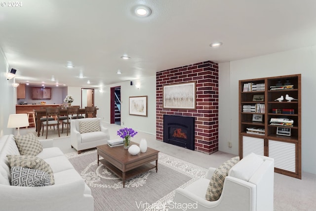 living room with light carpet and a brick fireplace