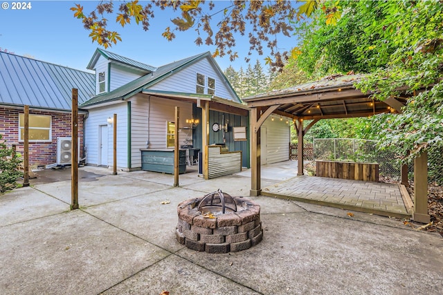 exterior space with a gazebo and a fire pit