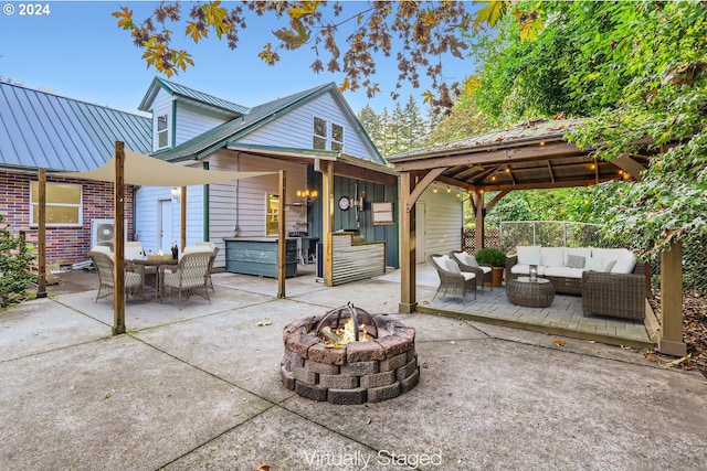 view of patio / terrace with a gazebo and an outdoor living space with a fire pit