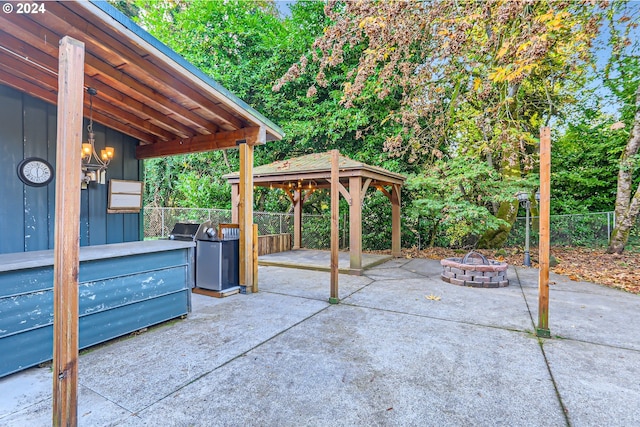 view of patio with a gazebo, an outdoor fire pit, and a grill