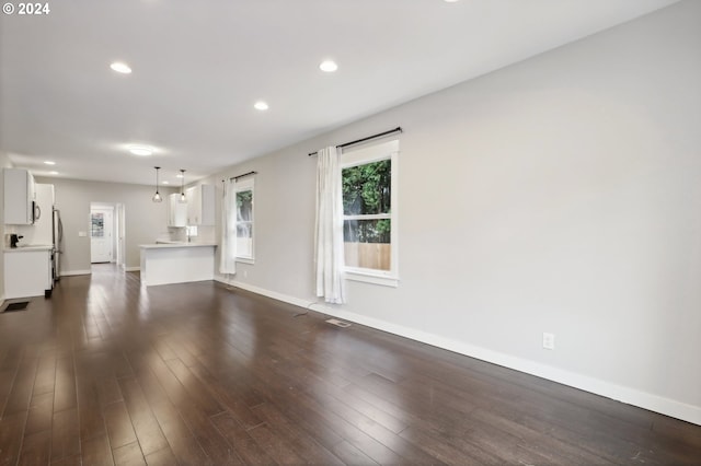 unfurnished living room featuring dark wood-type flooring