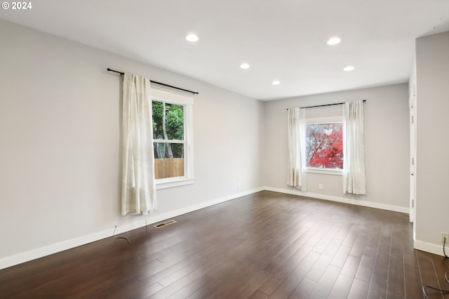 empty room featuring dark hardwood / wood-style flooring