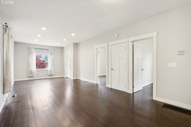 spare room with dark hardwood / wood-style floors