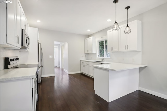 kitchen with dark hardwood / wood-style flooring, hanging light fixtures, white cabinets, and stainless steel appliances