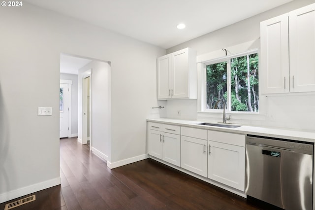 kitchen with stainless steel dishwasher, white cabinets, sink, and dark wood-type flooring