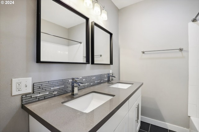 bathroom featuring decorative backsplash, tile patterned flooring, and vanity