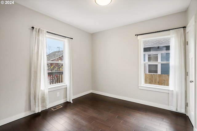 unfurnished room featuring dark wood-type flooring