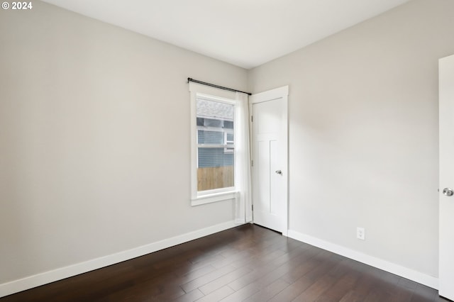 spare room with dark wood-type flooring