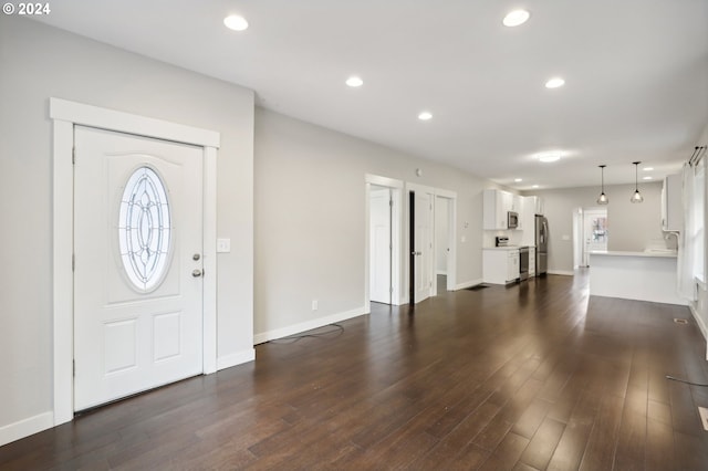 entryway featuring plenty of natural light, dark hardwood / wood-style flooring, and sink