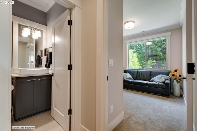 bathroom featuring vanity, ornamental molding, and tile patterned flooring