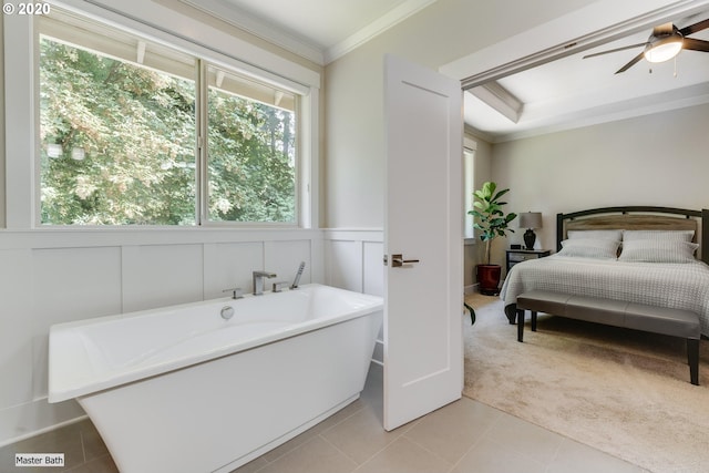full bathroom with ornamental molding, healthy amount of natural light, a freestanding tub, a ceiling fan, and ensuite bathroom