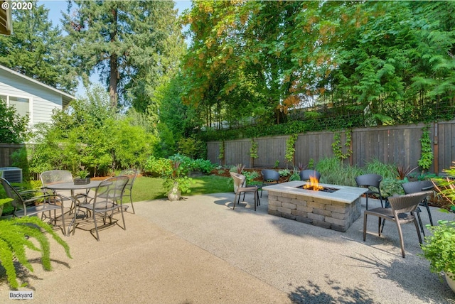 view of patio / terrace featuring a fire pit, fence, and outdoor dining area
