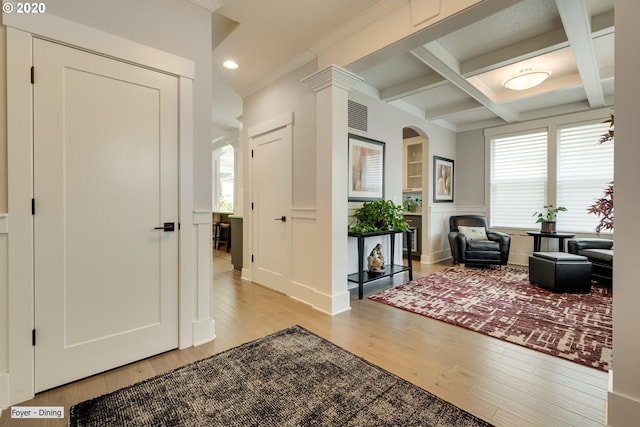 living area featuring light wood finished floors, plenty of natural light, beamed ceiling, coffered ceiling, and recessed lighting
