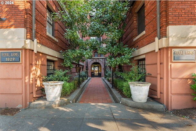 doorway to property featuring brick siding