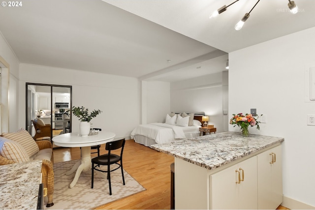 bedroom with light hardwood / wood-style floors