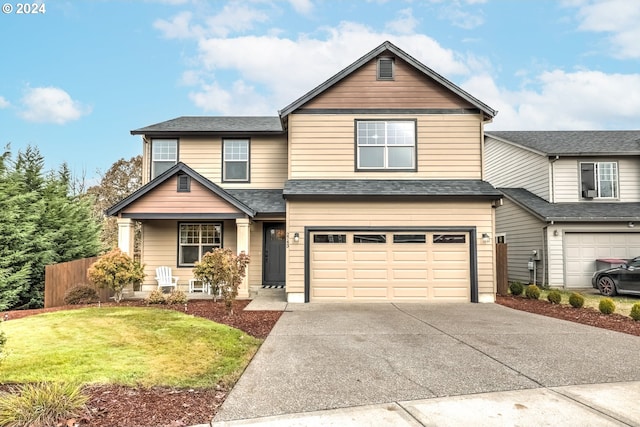 view of front of home with a garage and a front lawn