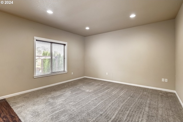 unfurnished room featuring carpet