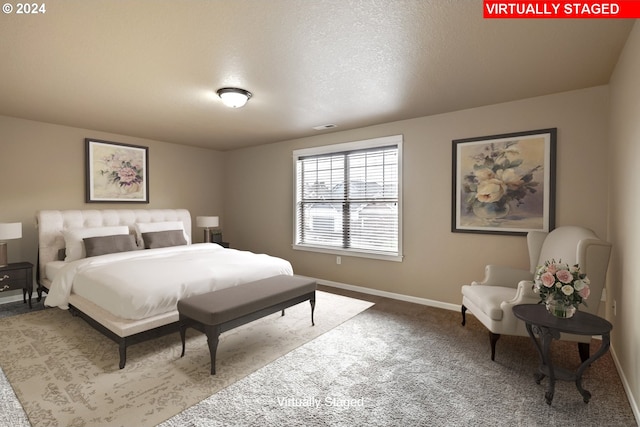 bedroom with a textured ceiling and carpet flooring