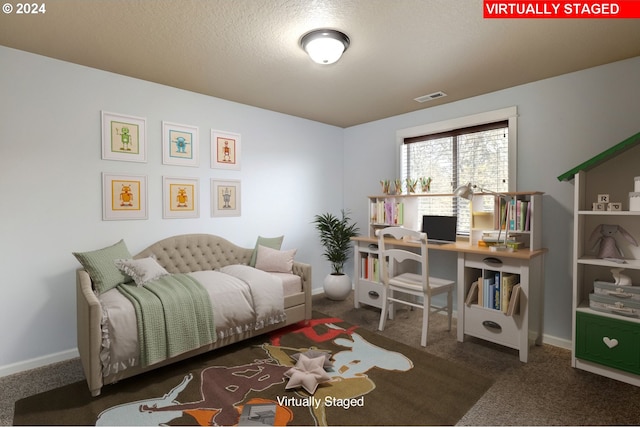 carpeted bedroom featuring a textured ceiling