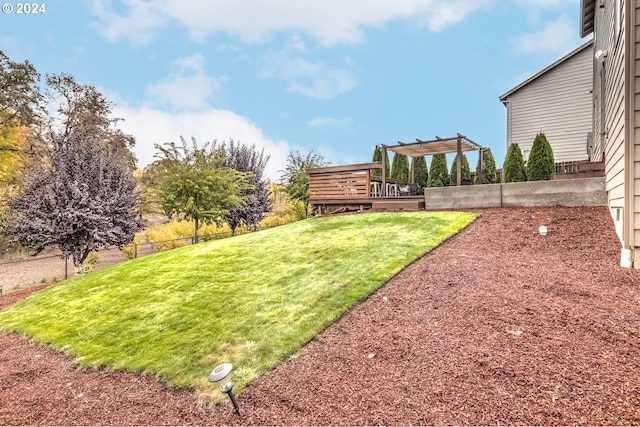 view of yard with a wooden deck and a pergola