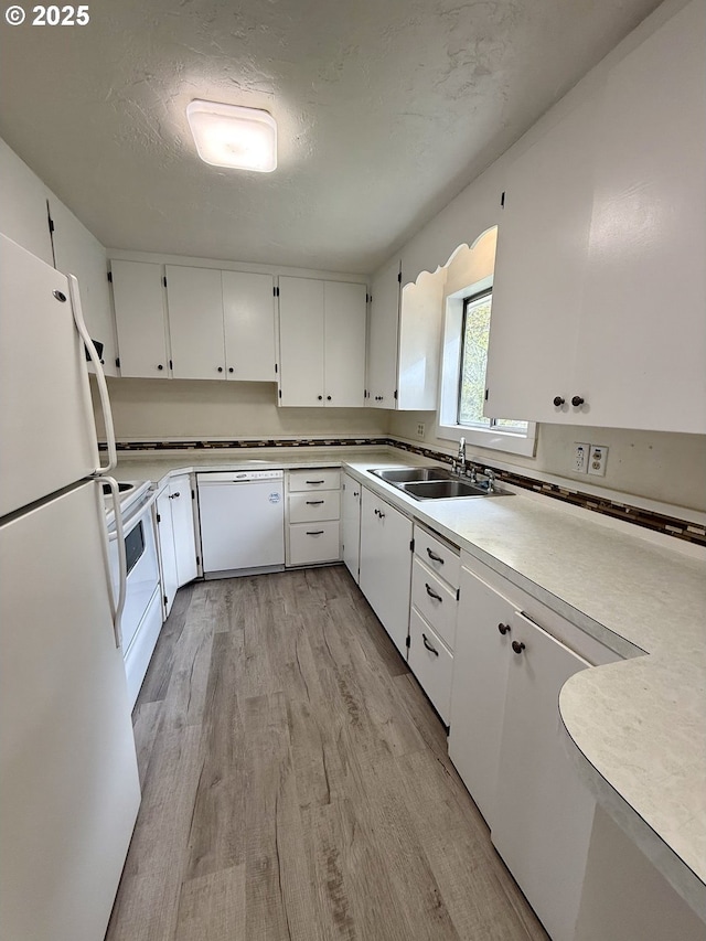 3973 Carnes Rd, Roseburg, OR 97471 - kitchen featuring white appliances, a sink, light wood finished floors, white cabinetry, and light countertops