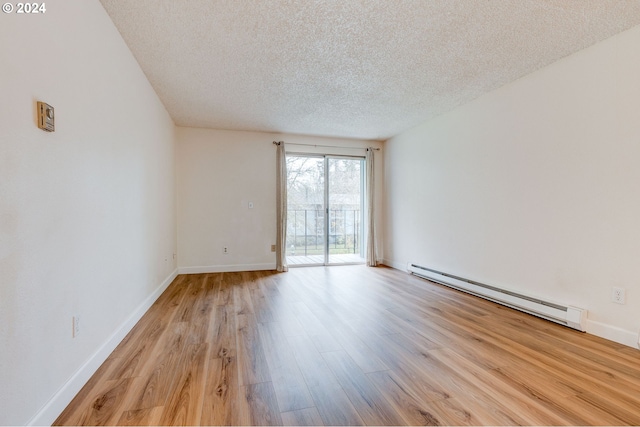 unfurnished room featuring a textured ceiling, light wood-type flooring, and baseboard heating