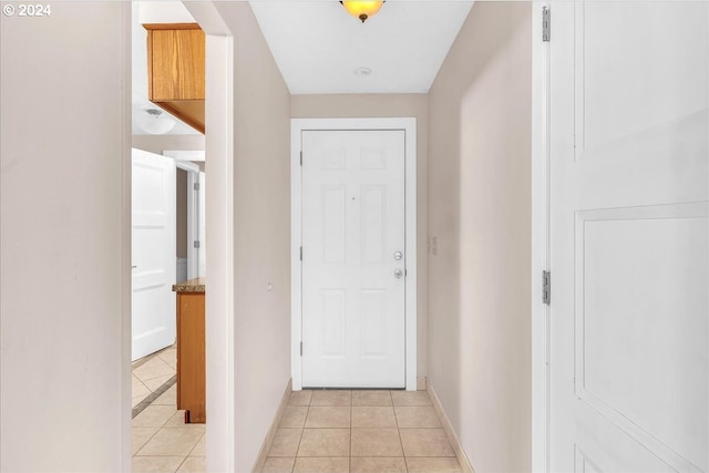 doorway with light tile patterned floors