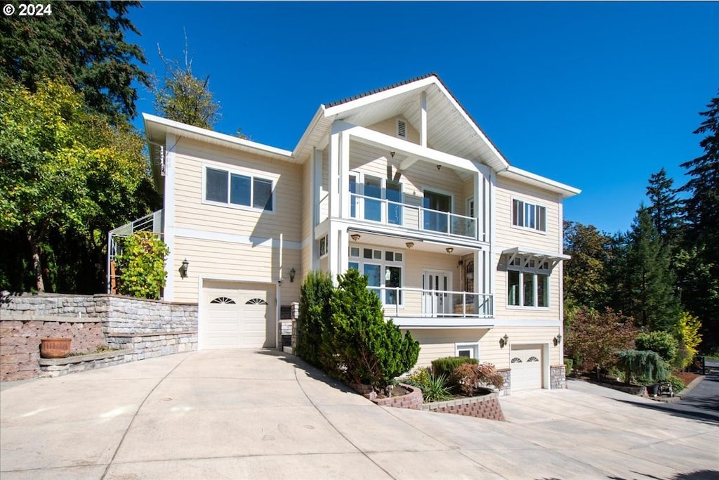 view of front of home with a balcony and a garage