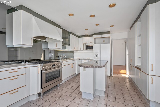 kitchen with white cabinetry, sink, a center island, and dishwasher