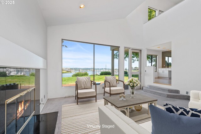 unfurnished living room with a towering ceiling and carpet