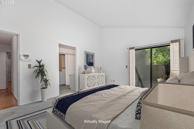 bedroom featuring access to outside, high vaulted ceiling, and carpet flooring