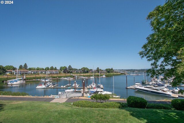 dock area featuring a lawn and a water view