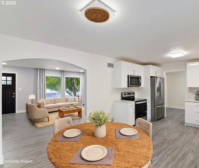 7331 SW Oak St, Tigard, OR 97223 - dining space with arched walkways and light wood finished floors