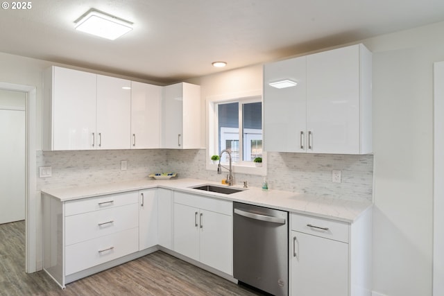 7331 SW Oak St, Tigard, OR 97223 - kitchen with stainless steel dishwasher, light wood-type flooring, white cabinets, and decorative backsplash