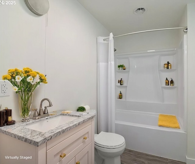 full bathroom featuring toilet, vanity, shower / bath combination with curtain, and hardwood / wood-style floors