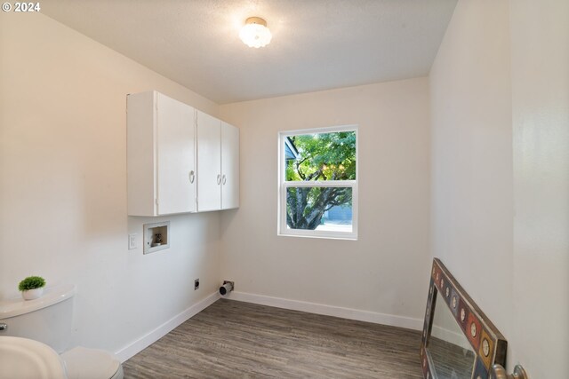 laundry room with washer hookup, cabinets, hookup for an electric dryer, and hardwood / wood-style flooring