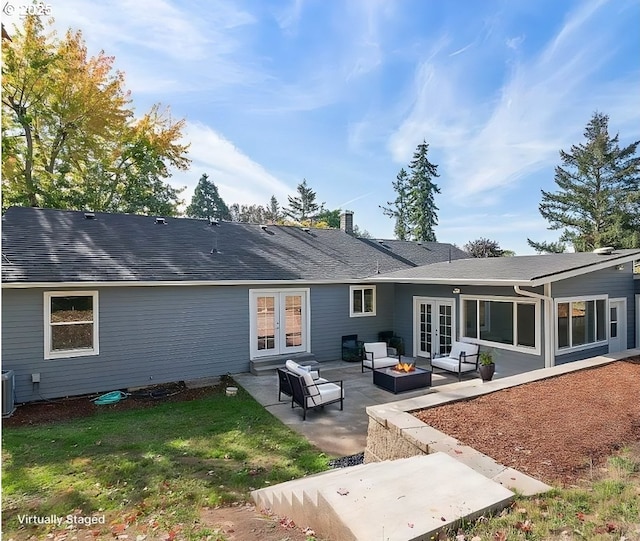 back of house with an outdoor living space with a fire pit, a patio, a yard, french doors, and cooling unit