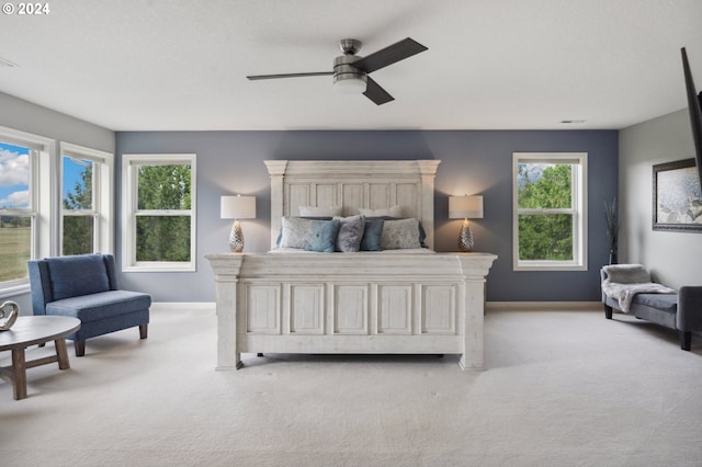 bedroom with ceiling fan and light carpet