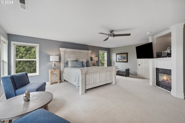 bedroom featuring light colored carpet and ceiling fan